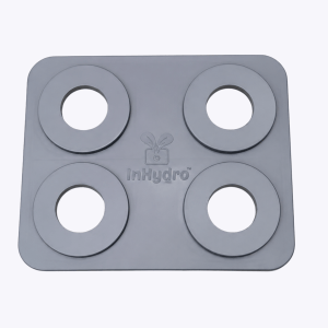 Close-up of a gray plastic tray with four large circular holes in a 2x2 grid, rounded corners visible.