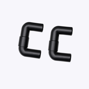 Close-up of black metal pipe elbows forming curved joints against a light background