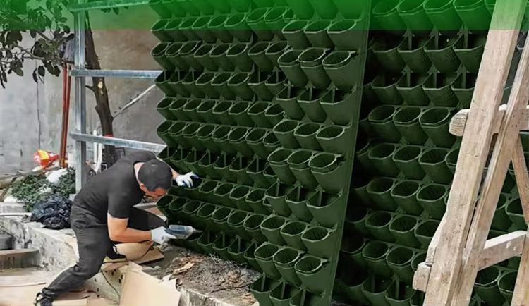 INHYDRO technician installing hydroponics wall panels on site